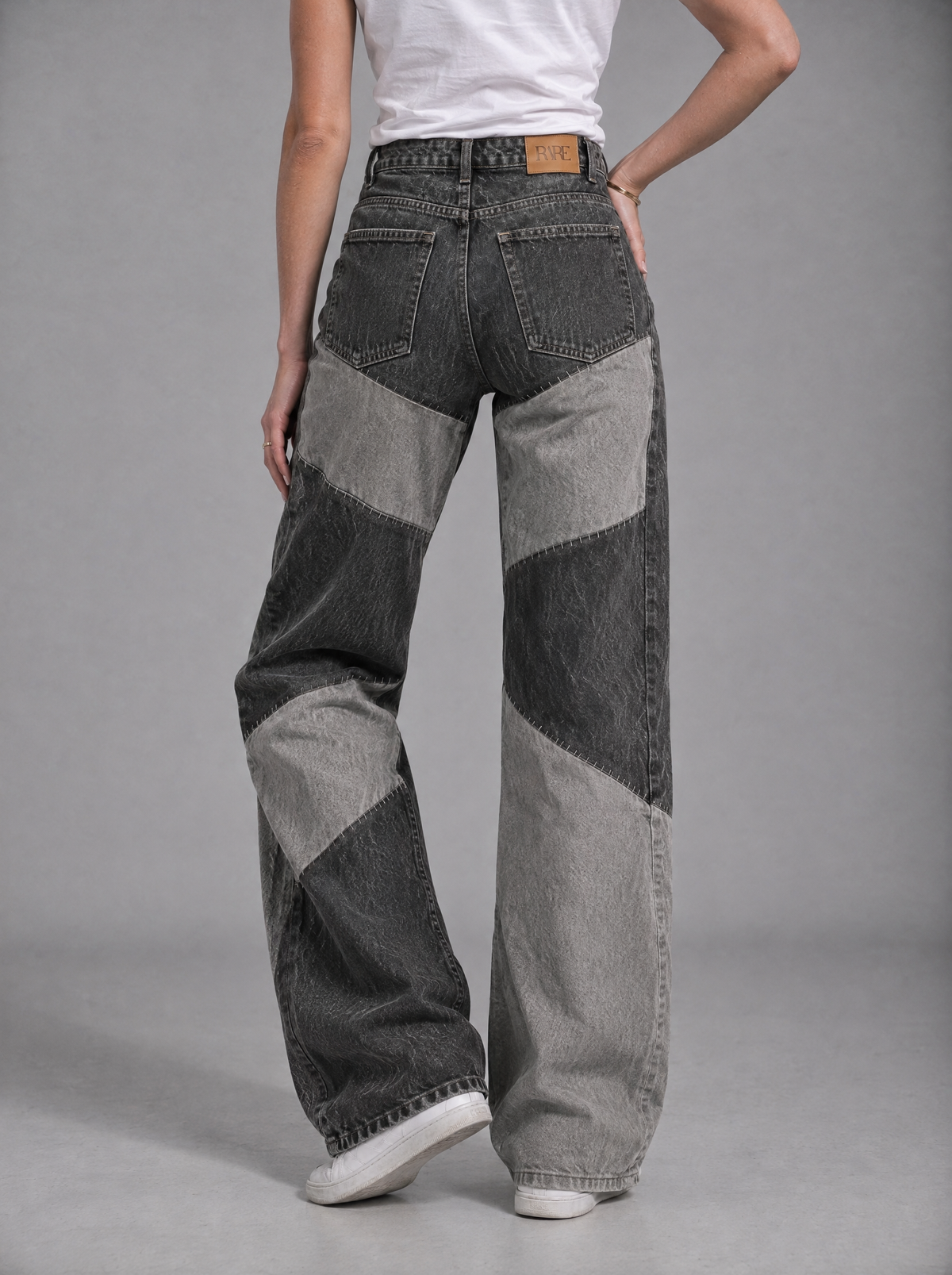 RARE Onyx black and grey patchwork jeans, back view with tan leather RARE patch