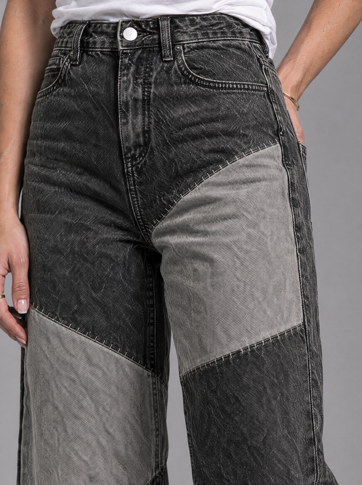 RARE Onyx jeans, close-up of black and grey patchwork seam