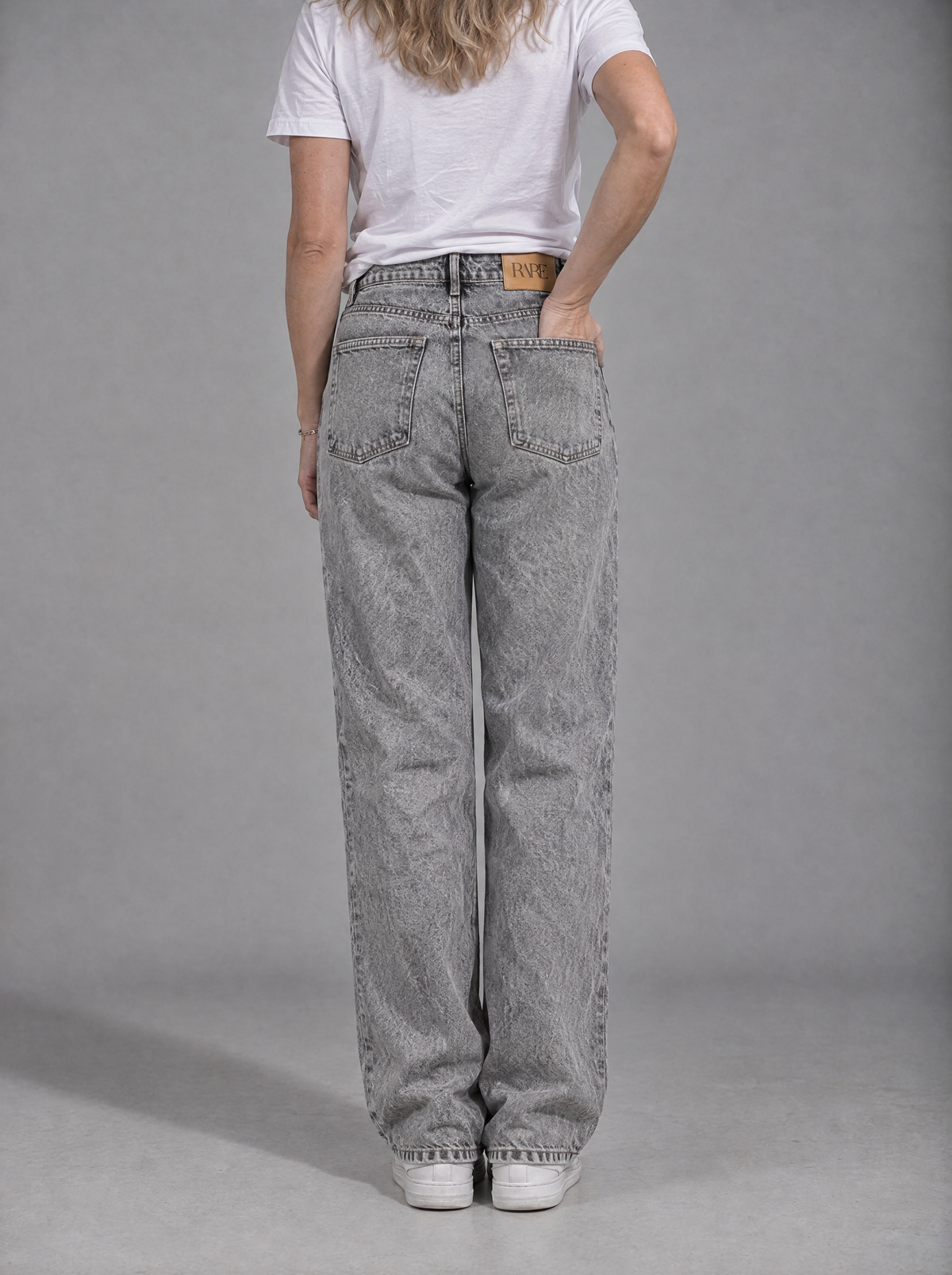 RARE Quartz grey acid wash jeans, back view with tan leather RARE patch