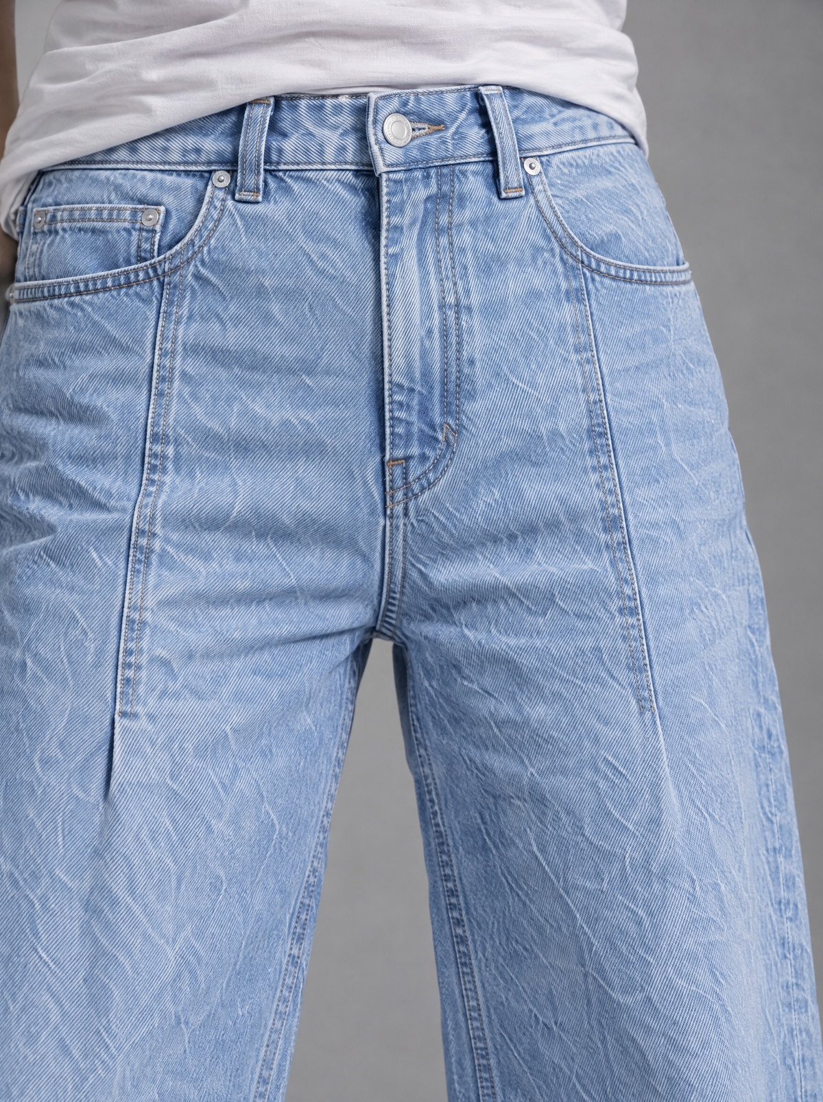 RARE Pearl jeans, close-up of sky blue denim, button and pocket